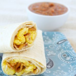 two meal prep egg and bacon burritos stacked