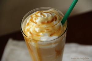 caramel macchiato in a tall glass with whipped cream and caramel sauce