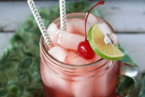 glass of boozy cherry limeade