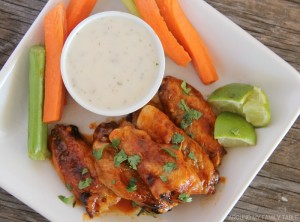 Honey Sriracha Chicken Wings on a platter with ranch dressing