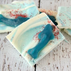 Satisfy your sweet tooth with this easy to make Shark Bark Candy. Be sure you make enough so you can handle the feeding frenzy during SHARK WEEK!