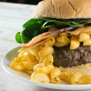 I've kicked up our plain ol' cheeseburger to this colossal Mac & Cheese Burger. A perfectly grilled burger topped with my favorite macaroni and cheese and of course loads of bacon...it's absolute perfection!