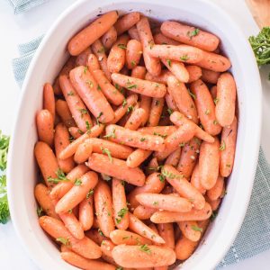 roasted baby carrots in a white pan